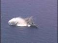 A torpedo hits a decomissioned U.S. Navy ship during RIMPAC
